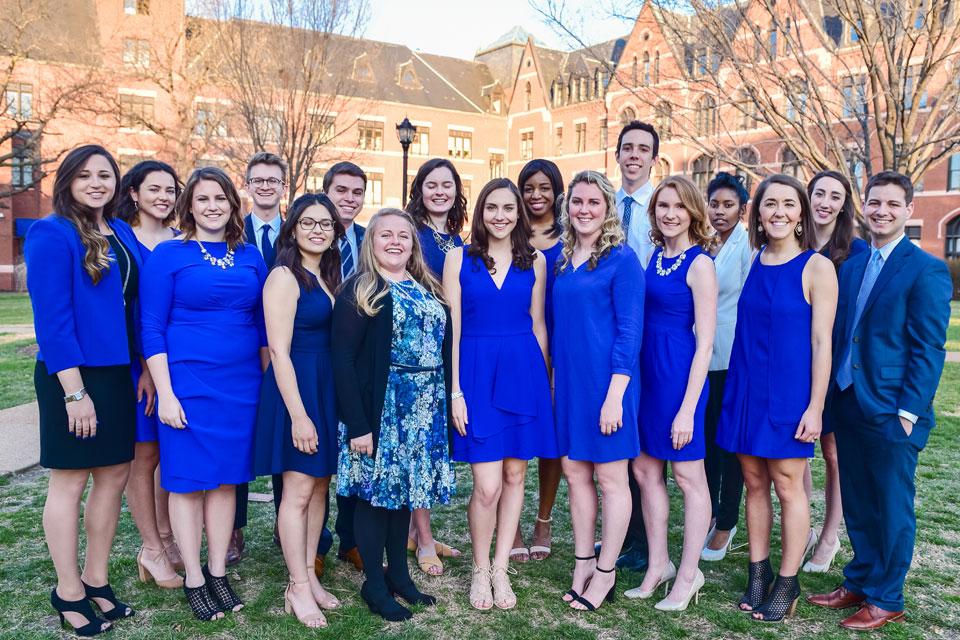 A group of students pose for a photo outside on campus.